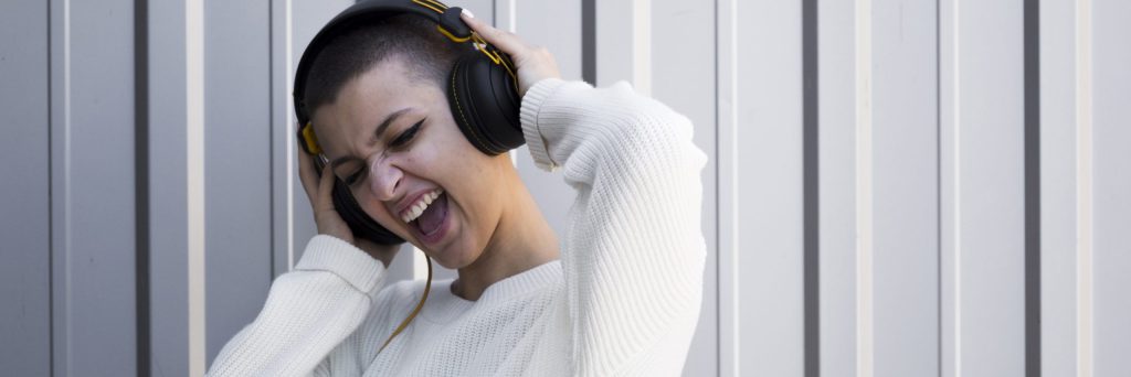 grimacing-young-woman-with-short-hair-listening-music-headphones grimacing-young-woman-with-short-hair-listening-music-headphones